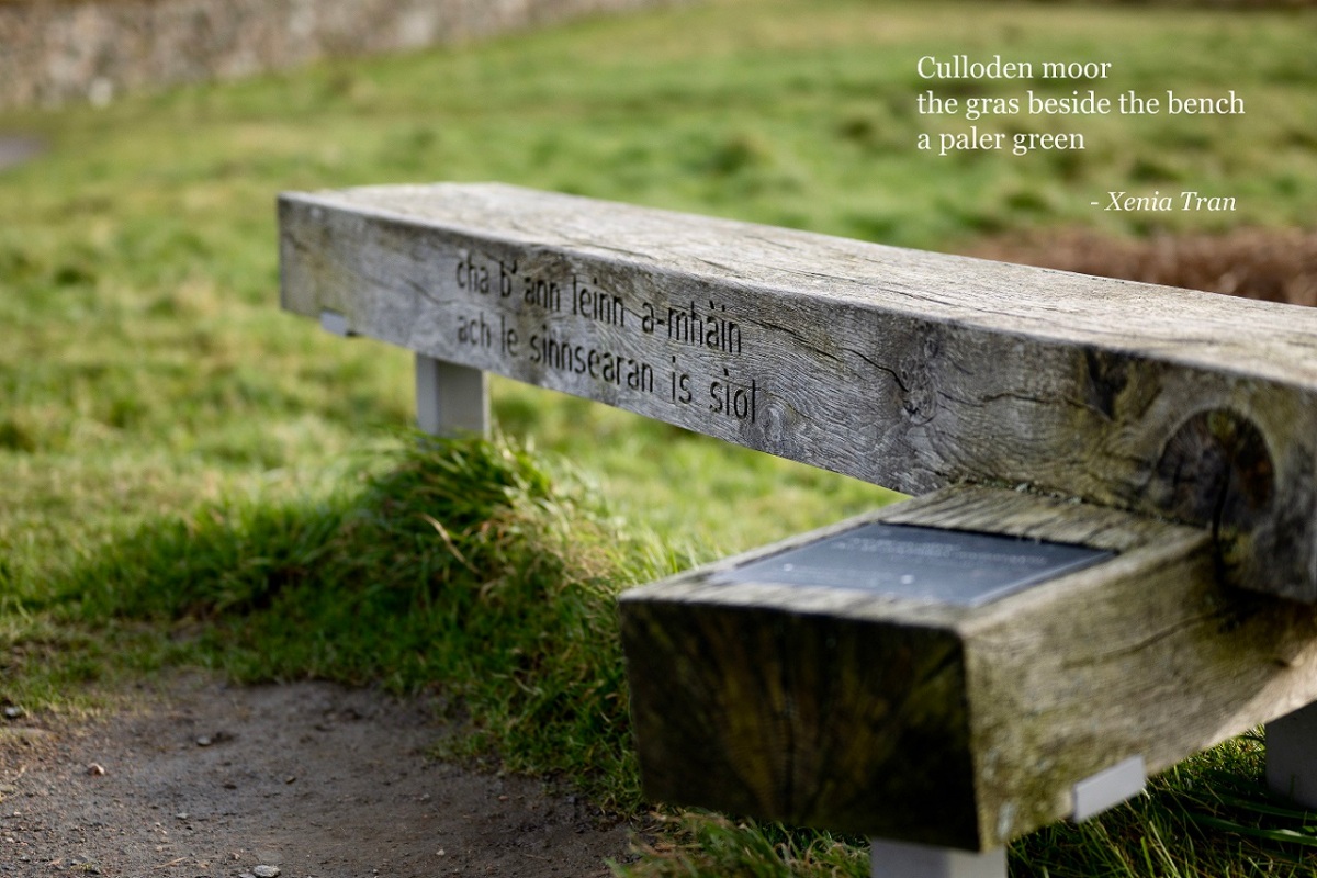 a haiku by Xenia Tran merged with an image of a wooden memorial bench at Culloden